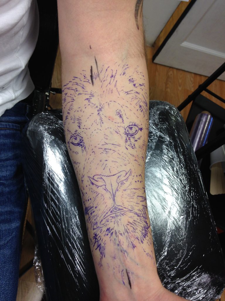 lion tattoo before with stencil